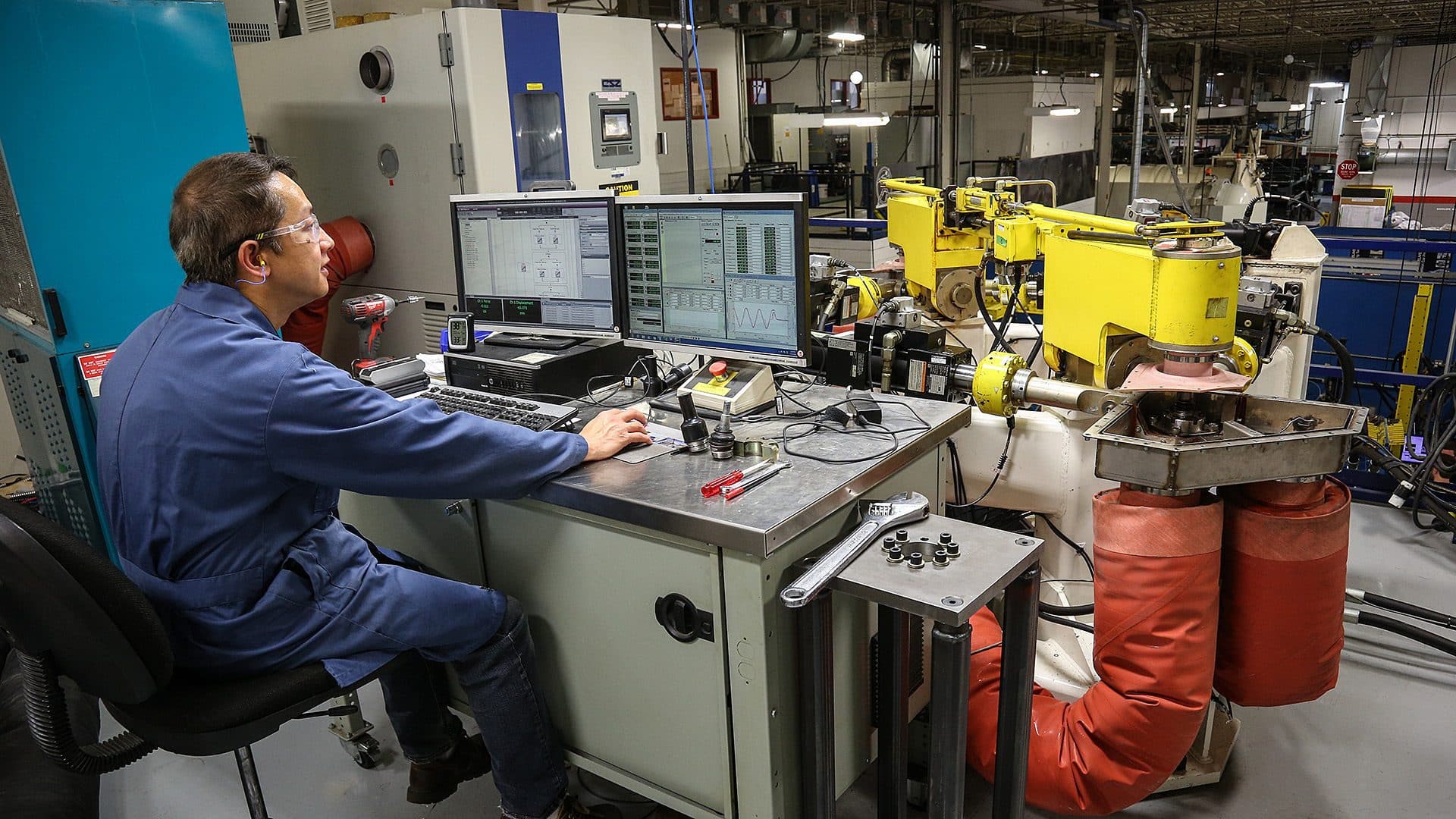 Man operating a durability testing machine